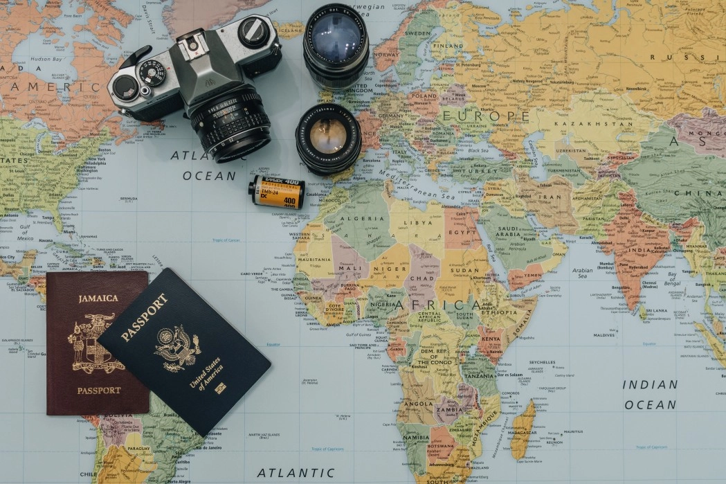 passport and a camera on a map